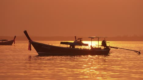 Fishermans-on-the-Long-Tail-boat-during-sunrise-in-Thailand,-Asia