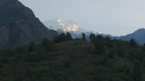 Landscape-with-hills-revealing-Mount-Manaslu-at-sunrise-in-Lamjung,-Nepal-Drone-shot-captures-the-beautiful-scenery-of-this-picturesque-tourist-destination