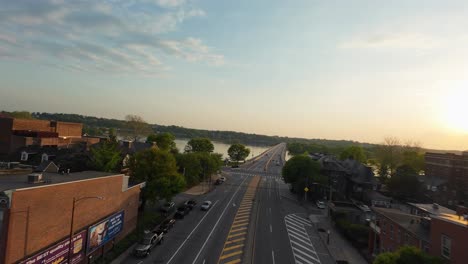 Aerial-flight-over-junction-in-Harrisburg-City-with-Susquehanna-River-during-sunset-time-in-background