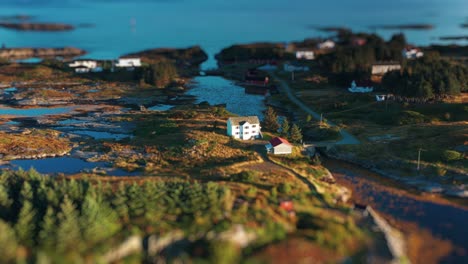 Aerial-view-of-the-picturesque-coastal-landscape-with-a-small-fishing-village-sitting-on-the-fjord-shore