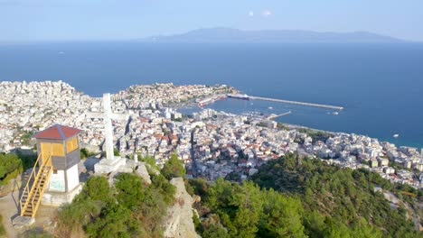 Aerial-Point-of-Interest-Shot-of-Kavala-City-Greece,-Showing-Cross-Monument-on-Mountain-and-Panorama-View-from