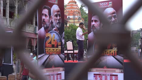 Indian-political-leaders-graphics-and-banners-on-the-streets,-Indian-news-channel-live-production-set-in-Chandni-Chowk-streets