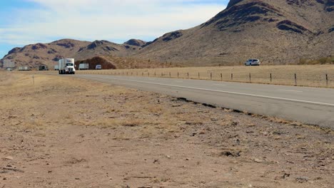 Single,-white-Fed-Ex-tractor-and-double-trailer-transporting-packages-across-the-USA-on-the-Interstate-in-western-Texas