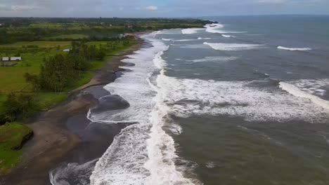 Aerial-view-of-the-Kerambitan-coastline-in-Karangasem,-Bali,-Indonesia,-with-its-pristine-beaches,-vibrant-greenery,-and-vast-ocean-scenery