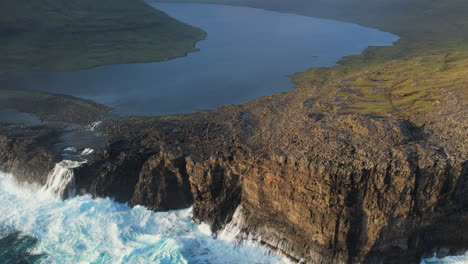 La-Magia-Del-Lago-Leitisvatn,-Islas-Feroe:-Cascada-Al-Atardecer-Y-Olas-Intensas