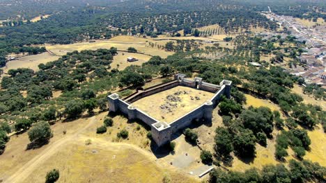 Drone-video-with-a-linear-tour-over-the-Castillo-de-Cala,-which-is-a-rehabilitated-building-located-on-a-hill