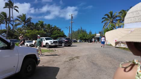 Hawaiian-girl-tourist-exploring-food-trucks-and-shops-in-Kahuku,-Oahu-Hawaii