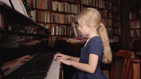 A-young-girl-skillfully-plays-a-grand-piano,-her-fingers-dancing-across-the-keys,-creating-beautiful,-melodic-music