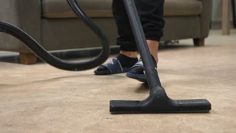 Person-cleaning-dirty-floor-with-a-power-steamer,-steaming-the-living-room-floor