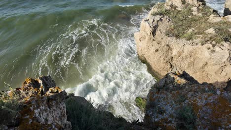 Waves-crash-against-rocky-formations-along-the-beautiful-coastline-of-Crimea-by-the-Sea-of-Azov,-showcasing-the-area's-natural-beauty-and-serenity