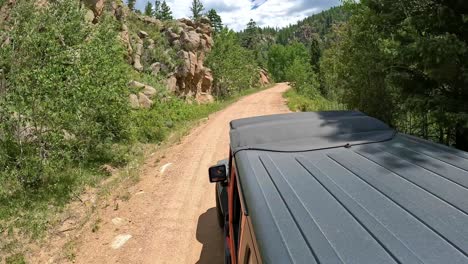 POV---Driver-closes-the-sun-roof-while-driving-on-a-scenic-gold-belt-byway-in-Rocky-Mountains