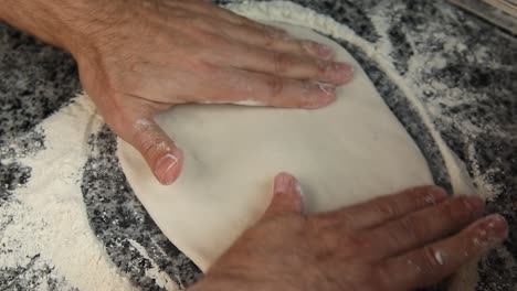 A-chief-Kneads-the-dough-to-make-Italian-pizza,-close-up-shot,-insert-shot