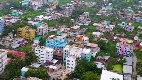 Urbanization-of-Asian-city-in-Bangladesh,-aerial-developing-town,-drone-descending