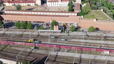 ItaliaRail-in-Florence,-Italy-leaving-the-station---aerial-follow