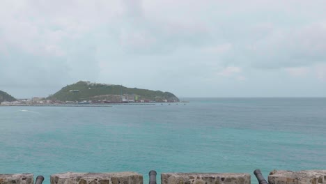 Tilt-up-shot-of-cannons-in-remains-of-historic-Fort-Amsterdam-overlooking-Philipsburg-and-Great-Bay-on-the-Dutch-side-of-Caribbean-Island-in-Saint-Martin