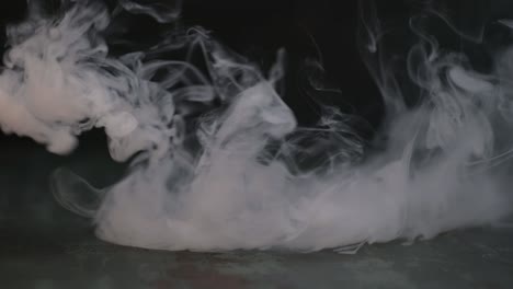 Abstract-movement-of-white-smoke,-steam-on-dark-background