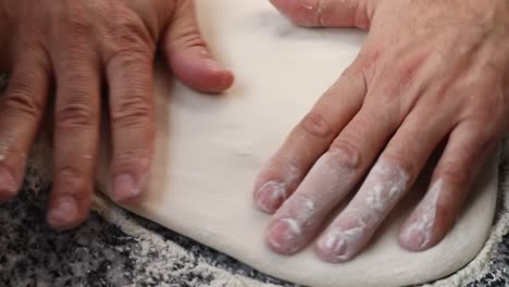 A-chief-Kneads-the-dough-to-make-Italian-pizza,-close-up-shot,-insert-shot