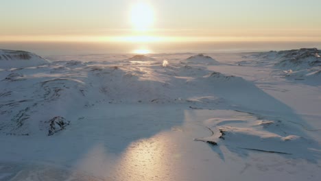 Sunset-Drone-View-of-Frozen-Kleifarvatn-Lake-and-Snowy-Landscape