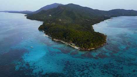 reverse-dolly-aerial-view-Tanjung-Gelam,-a-tip-of-Karimunjawa-Island-with-a-white-sand-beach-and-crystal-clear-sea,-Central-Java---Indonesia