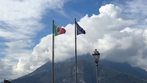 Lake-Como-and-European-flag-waving-in-nature-with-mountains-in-Italy