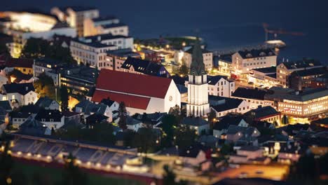 Nighttime-footage-of-the-Molde-coastal-town,-with-lights-reflecting-on-the-water-and-illuminating-the-harbor