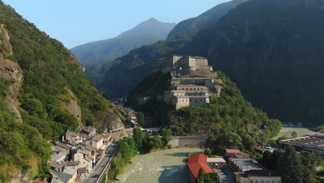 Fort-Bard-in-Aosta-Valley,-Italy,-captured-in-a-stunning-aerial-view-on-a-sunny-day