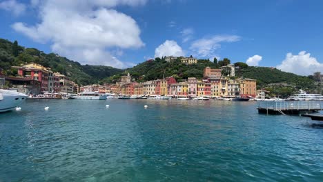 established-view-from-mediterranean-sea-of-Portofino,-Italy-famous-travel-destination-yacht-moored-at-bay