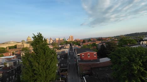 Drone-flight-over-suburb-neighborhood-of-small-american-town-at-sunset