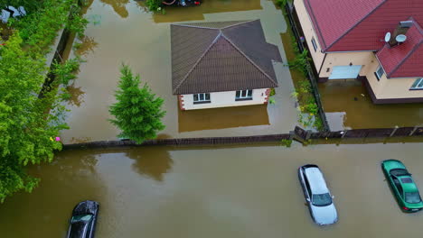 Aerial-view-of-storm-aftermath,-cars,-streets,-houses-and-yards-flooded-under-water