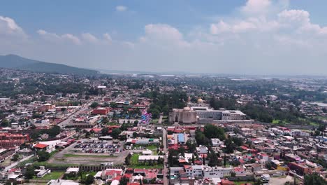 Drone-approaching-the-center-of-the-magic-town-of-Tepotzotlan-in-the-State-of-Mexico,-near-Mexico-City,-on-a-Sunday-of-activity-at-noon