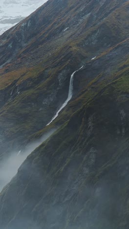 Nepal-Waterfall-in-Rugged-Mountains-Scenery,-Vertical-Video-for-Social-Media-Instagram-Reels-and-Tiktok-of-Dramatic-Atmospheric-Moody-Rocky-Mountain-Landscape-in-the-Himalayas-in-Nepal