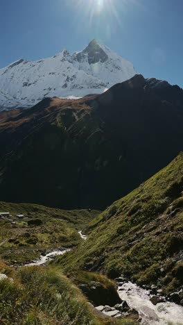 Vertical-River-and-Snowcapped-Mountains-Landscape,-Vertical-Video-for-Social-Media-Instagram-Reels-and-Tiktok-of-Nepal-Mountain-River-and-Stream-Scenery-with-Flowing-Water-on-Blue-Sky-Sunny-Day