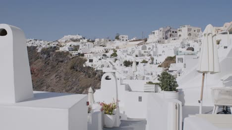 Whitewashed-buildings-in-Fira,-Santorini,-under-a-clear-blue-sky