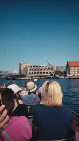 Vertical-view-of-tourists-sightseeing-by-boat-on-Copenhagen's-canal