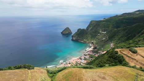 Praia-de-são-lourenço's-stunning-coastline-with-clear-blue-waters-and-lush-hills,-aerial-view