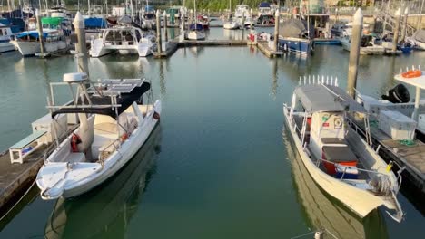 A-tilt-up-shot-of-fleet-of-sailing-yachts-docked-at-the-Raffles-Marina-Lighthouse-Pier-in-the-afternoon