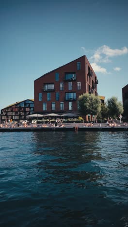 Vertical-view-of-people-sunbathing-on-Copenhagen's-canal