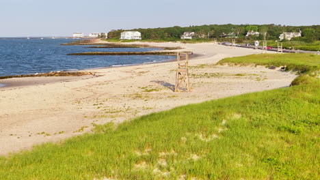 An-empty-cape-cod-beach-with-a-lifeguard-tower-on-a-sunny-day,-aerial-view