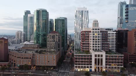 The-aerial-view-from-a-drone-captures-Rincon-Park-and-downtown-San-Francisco,-offering-a-unique-perspective-of-the-iconic-area,-urban-park-space,-and-historic-waterfront-buildings