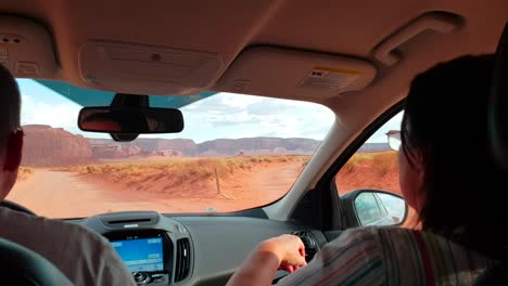 Inside-gimbal-stabilized-shot-of-SUV-driving-on-uneven-path-with-passengers-being-shaken-in-Monument-Valley,-Arizona,-USA