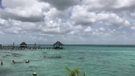 Crystal-Clear-Water-Changing-it's-Color-with-the-Sunlight-in-a-Partially-Cloudy-day-in-Bacalar-Lagoon,-Mexico