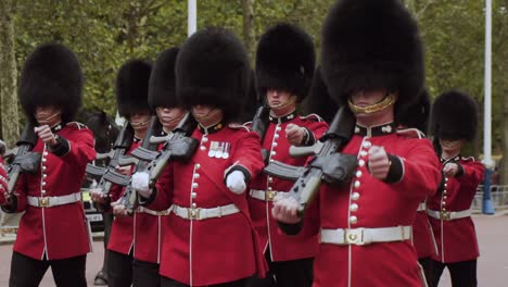 London-Queen's-Guard-infantry-and-cavalry-soldiers-walk-and-march-with-firearms-on-United-Kingdom's-street,-handheld-portrait-close-up-slow-motion