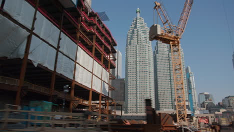 Toronto-financial-district-skyline-during-the-day-as-seen-from-a-moving-vehicle-on-the-highway