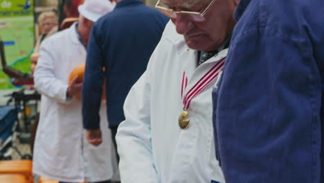 The-judge-checks-the-quality-of-cheese-on-a-traditional-cheese-market-in-Gouda