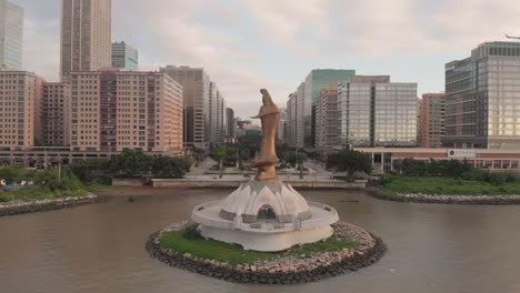 Aerial-pull-back-shot-of-famous-Kun-Iam-statue-in-NAPE-area-of-Macau