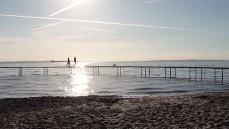 Circular-infinite-bridge-in-Aarhus,-Denmark-with-people-walking-on-it