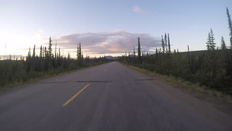 Driving-towards-the-sun-in-Alaska,-the-gopro-is-attached-to-the-car-on-a-gimbal