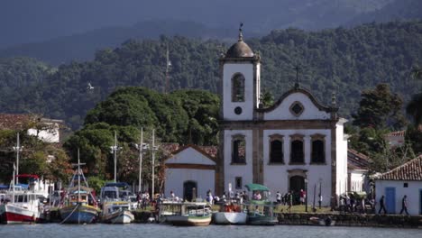 Long-shot-of-historic-Igreja-Santa-Rita-in-downtown-Paraty-with-tourists-on-winter-day-in-Brazil