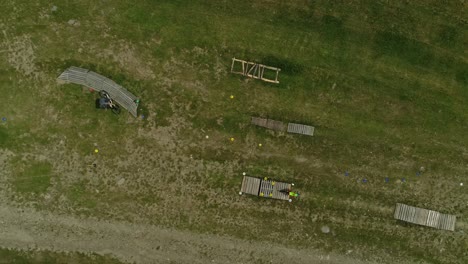 Bikers-Practicing-On-Grassy-Field-With-Obstacles-At-Bike-Park-Kasina-In-Kasina-Wielka,-Poland