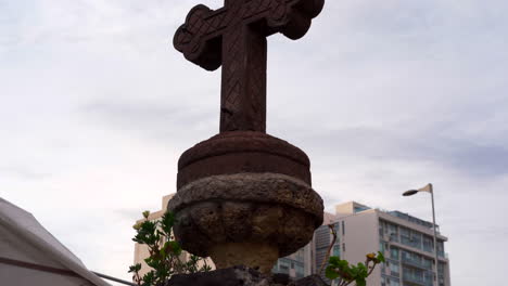 Cross-fountain-in-garden-panning-up-blue-sky